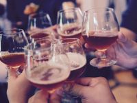 group of beer-filled glasses having a toast